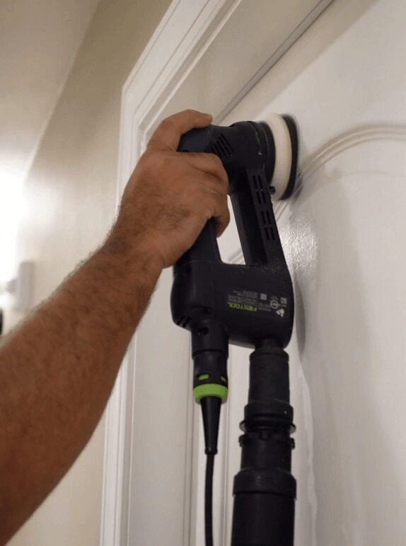 Trim refinishing in Tampa, sanding a paneled door